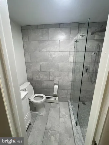 a bathroom with a toilet and a shower