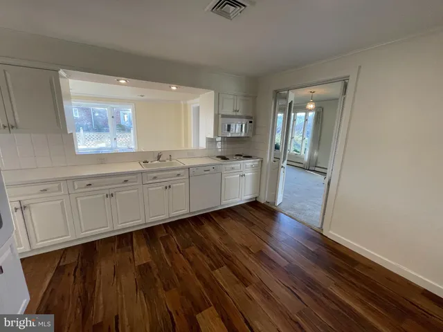 a room with hard wood floors and a sink