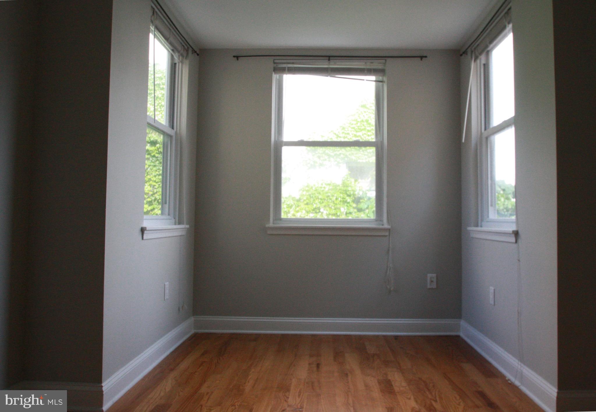 763 South 15th Street, Unit 2 Philadelphia, PA 19146 - Photo 11 of 12 a view of an empty room with wooden floor and a window