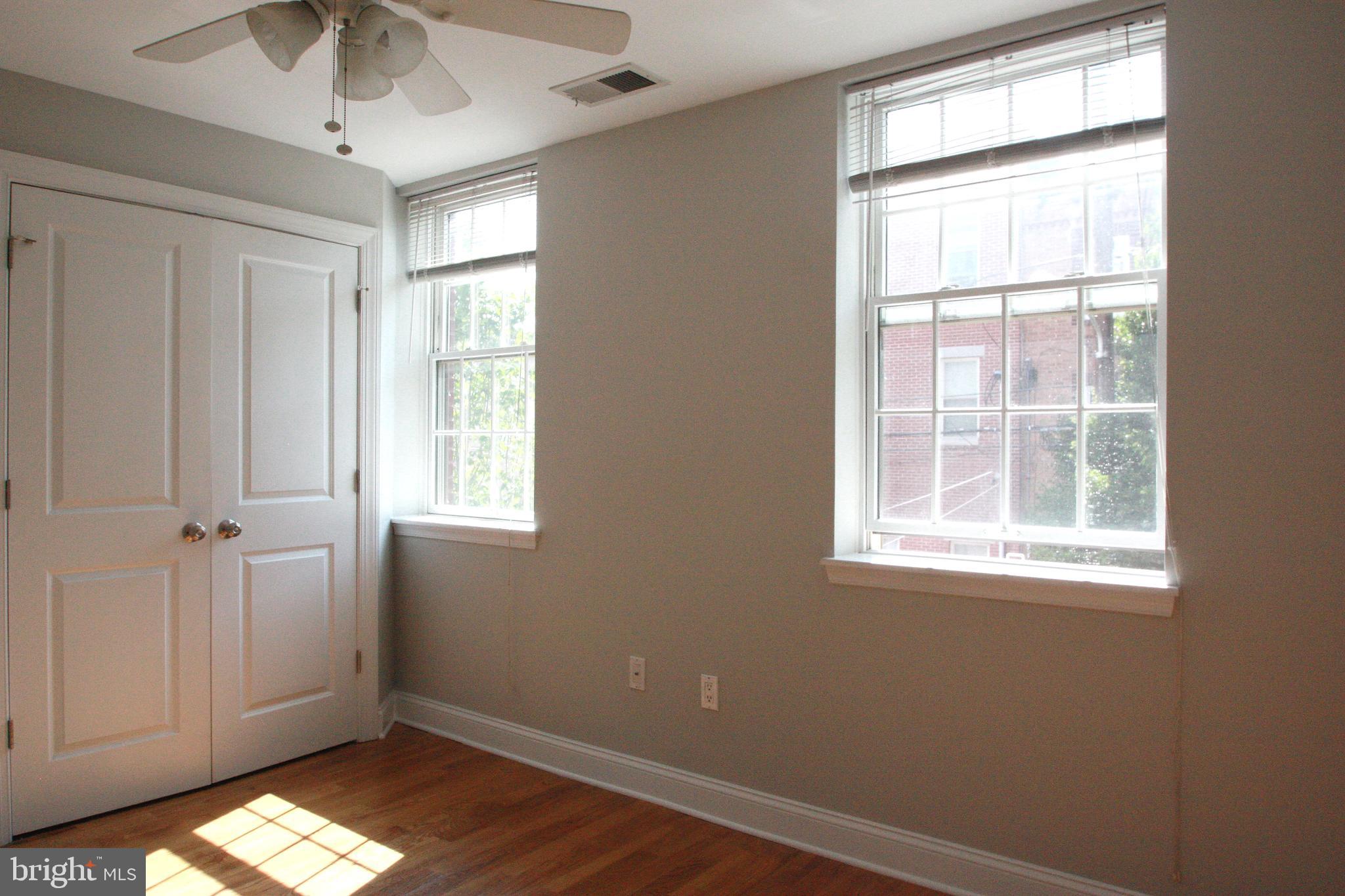 763 South 15th Street, Unit 2 Philadelphia, PA 19146 - Photo 6 of 12 an empty room with a window and wooden floor