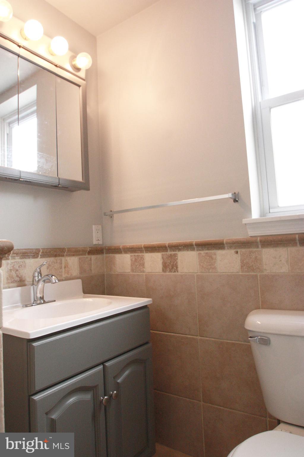 763 South 15th Street, Unit 2 Philadelphia, PA 19146 - Photo 8 of 12 a bathroom with a sink a toilet and a mirror