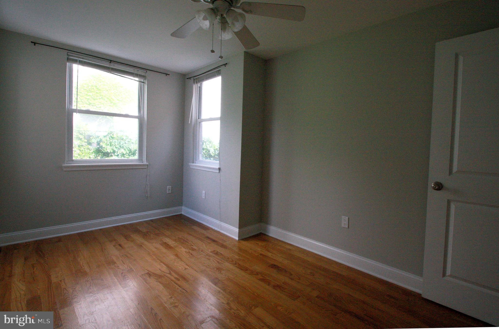 763 South 15th Street, Unit 2 Philadelphia, PA 19146 - Photo 10 of 12 an empty room with wooden floor and windows