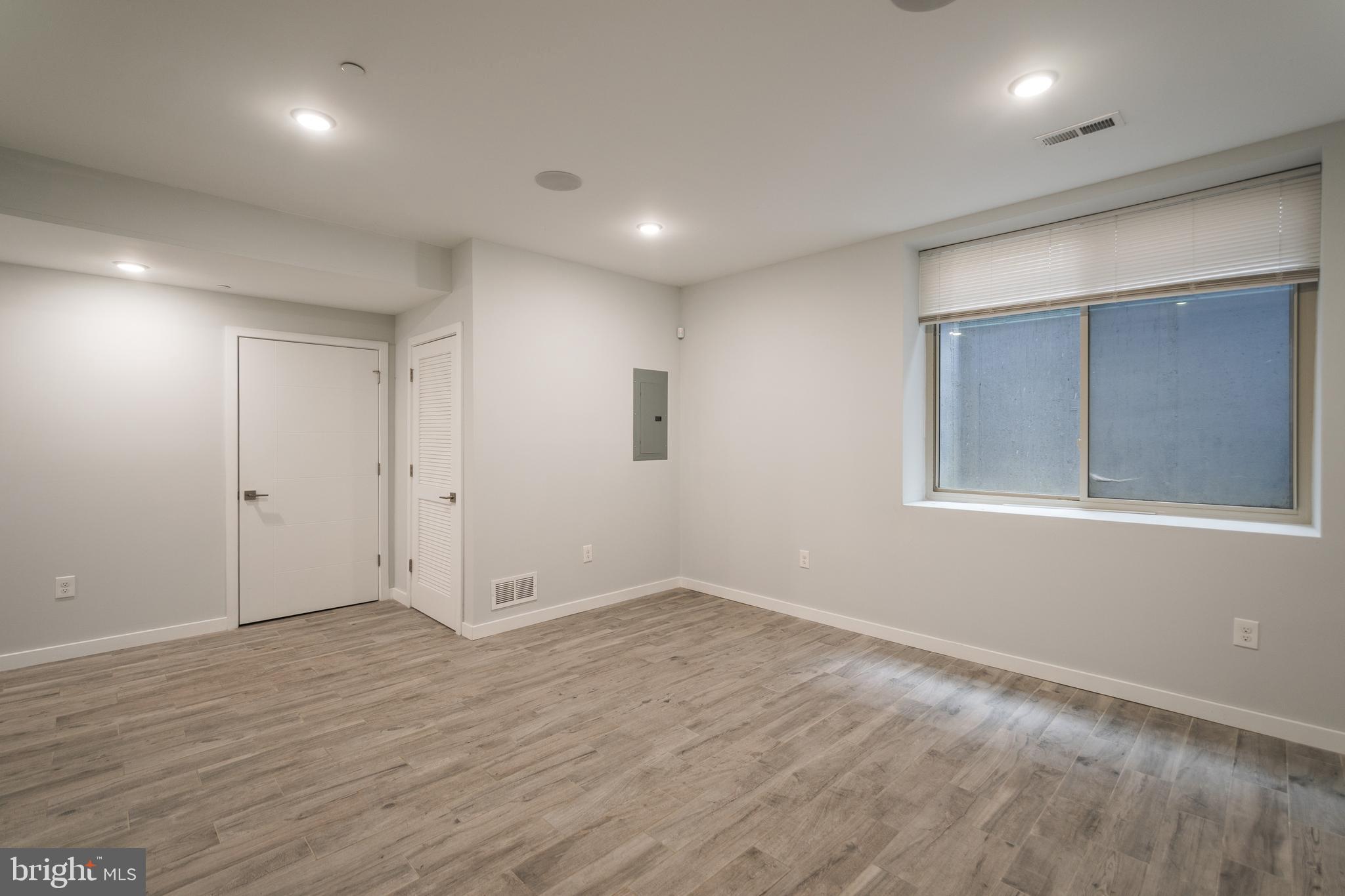 1524 North 8th Street, Unit 2 Philadelphia, PA 19122 - Photo 18 of 22 an empty room with wooden floor and windows