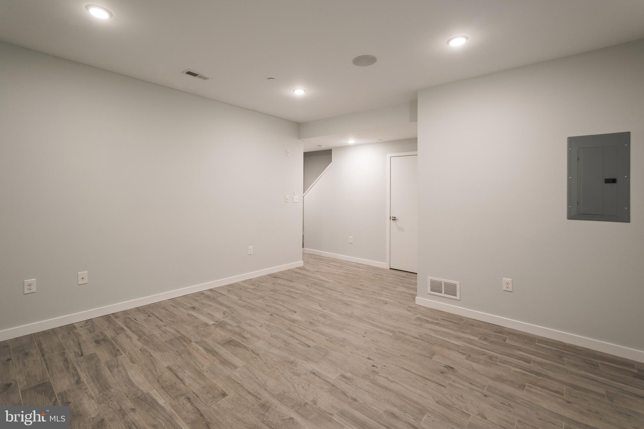 1524 North 8th Street, Unit 2 Philadelphia, PA 19122 - Photo 19 of 22 an empty room with wooden floor and windows
