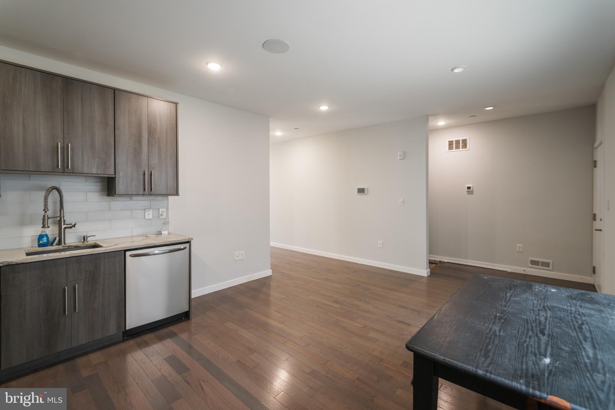 1524 North 8th Street, Unit 2 Philadelphia, PA 19122 - Photo 4 of 22 a kitchen with stainless steel appliances wooden floors and view living room