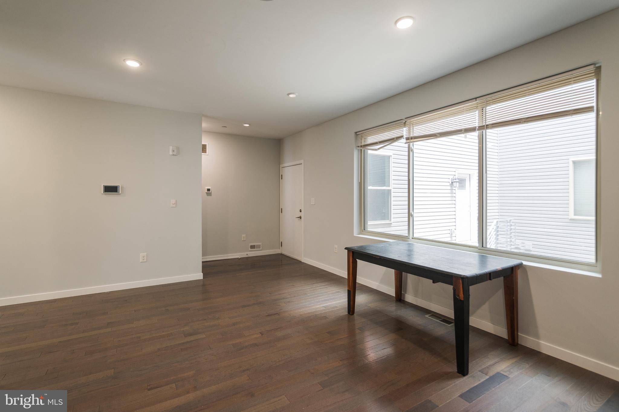 1524 North 8th Street, Unit 2 Philadelphia, PA 19122 - Photo 5 of 22 a view of an empty room with wooden floor and a window