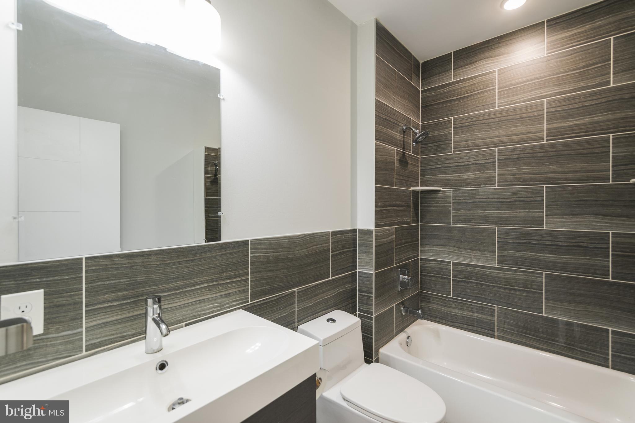 1524 North 8th Street, Unit 2 Philadelphia, PA 19122 - Photo 6 of 22 a bathroom with a sink toilet and shower