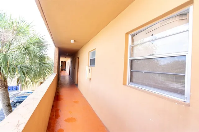 a hallway with a large window and sign broad
