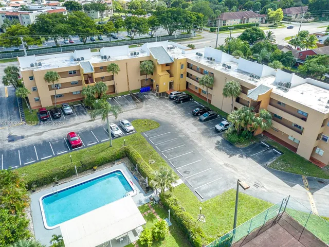 an aerial view of a house with a garden and lake view