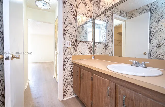 a bathroom with a granite countertop sink and a mirror