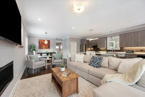 a kitchen with a sink stainless steel appliances and wooden floor