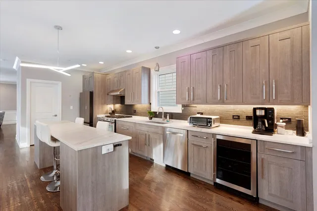 a kitchen that has a sink a stove and wooden floor