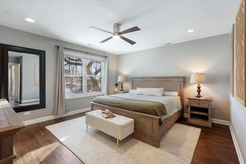 a spacious bathroom with a granite countertop sink a toilet mirror and bathtub
