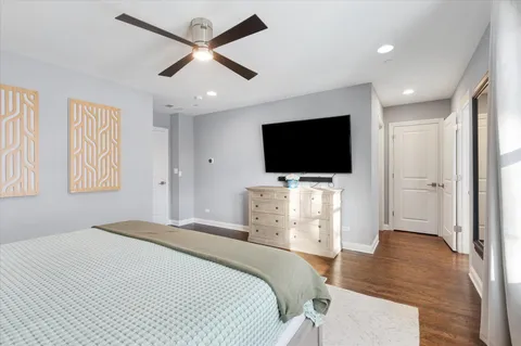 a view of walk in closet with wooden floor and a cabinet