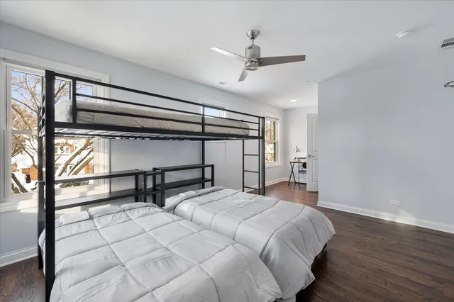 a bed room with a bed and a chair