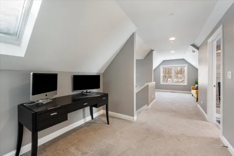 a backyard of a house with wooden fence and large trees