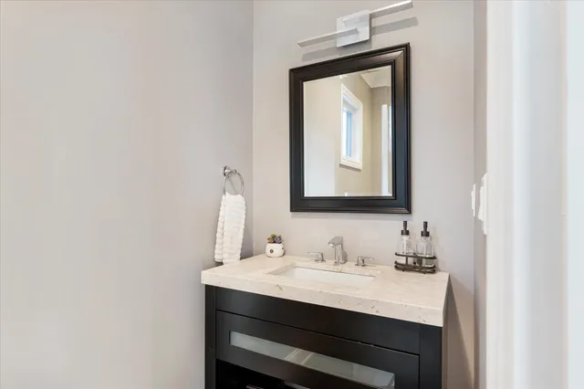 a bathroom with a sink vanity and a mirror