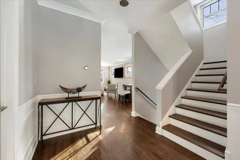 a view of entryway and hall with wooden floor