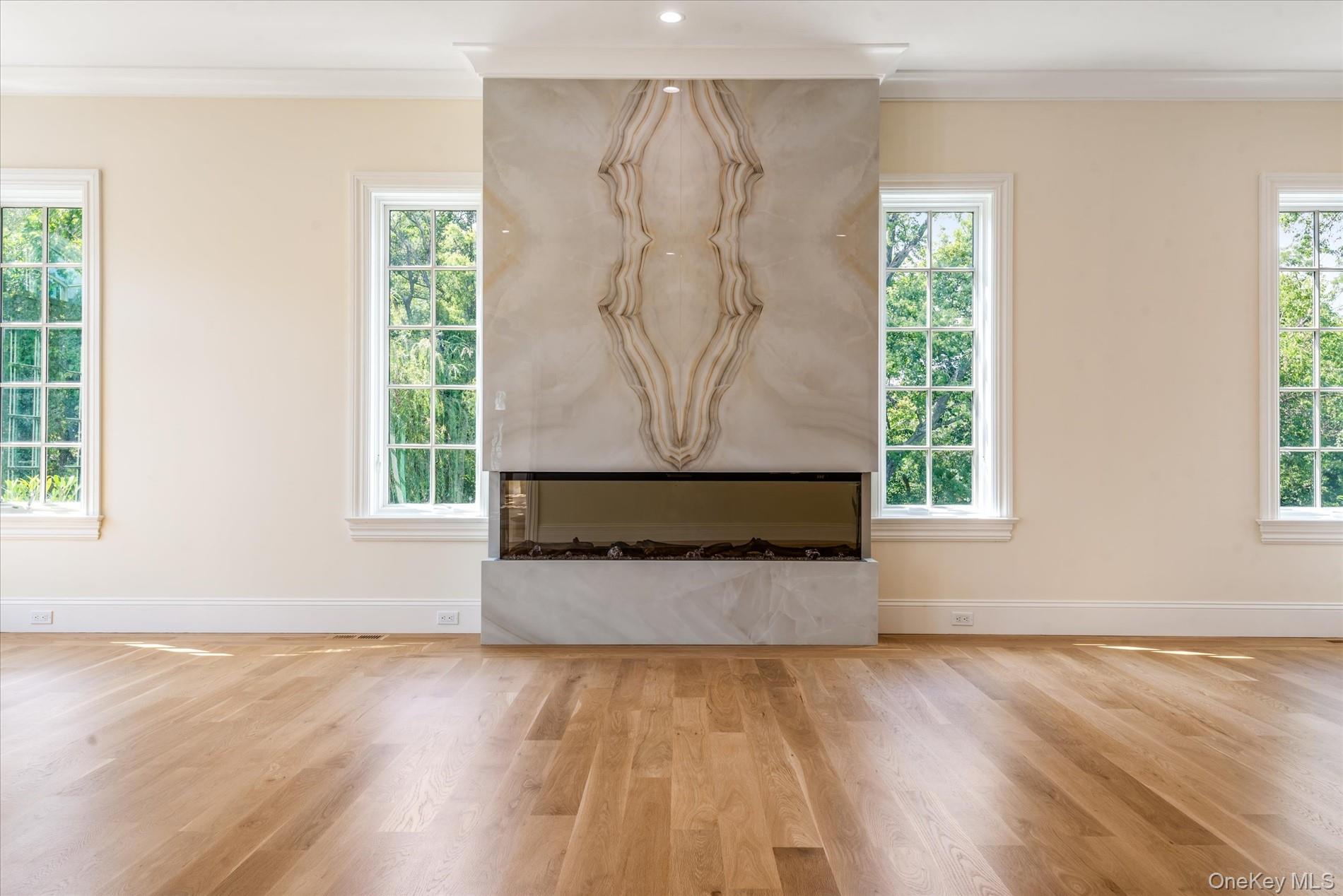 566 East Shore Road Great Neck, NY 11024 - Photo 14 of 50 an empty room with wooden floor and a window