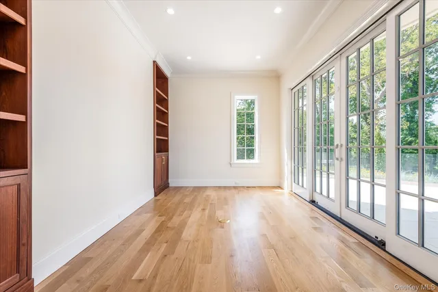 a view of an empty room and wooden floor