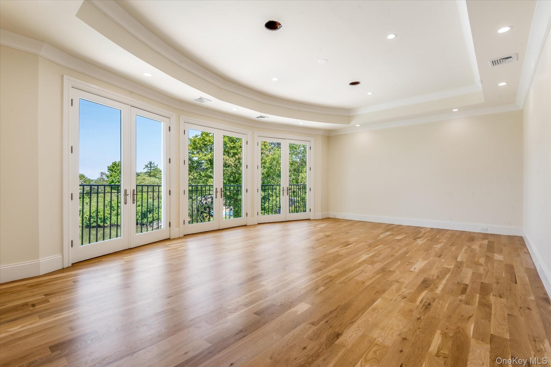 566 East Shore Road Great Neck, NY 11024 - Photo 25 of 50 a view of an empty room with wooden floor and a window
