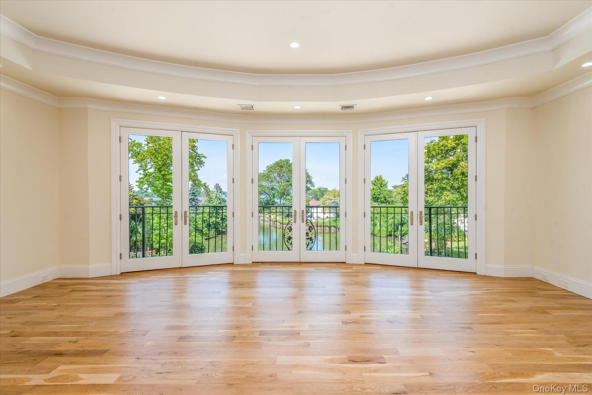 566 East Shore Road Great Neck, NY 11024 - Photo 26 of 50 a view of an empty room with wooden floor and a window
