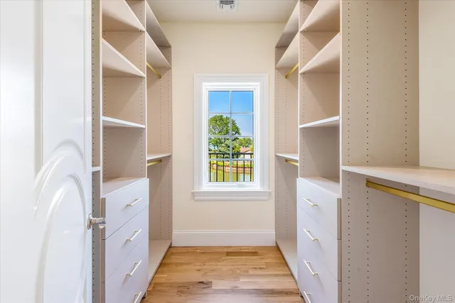 a hallway with cabinets and wooden floor