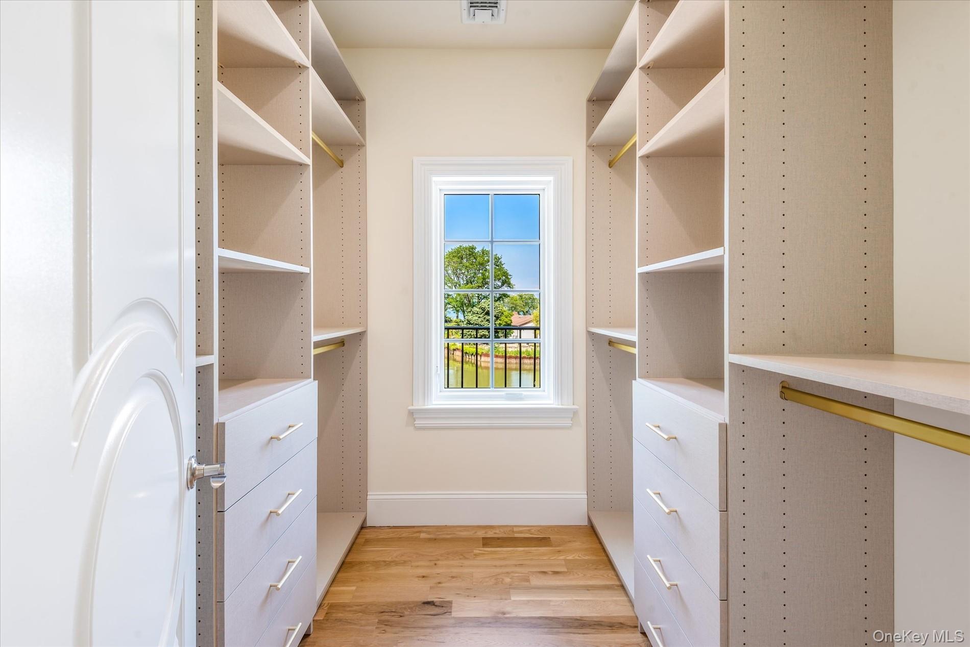 566 East Shore Road Great Neck, NY 11024 - Photo 30 of 50 a hallway with cabinets and wooden floor
