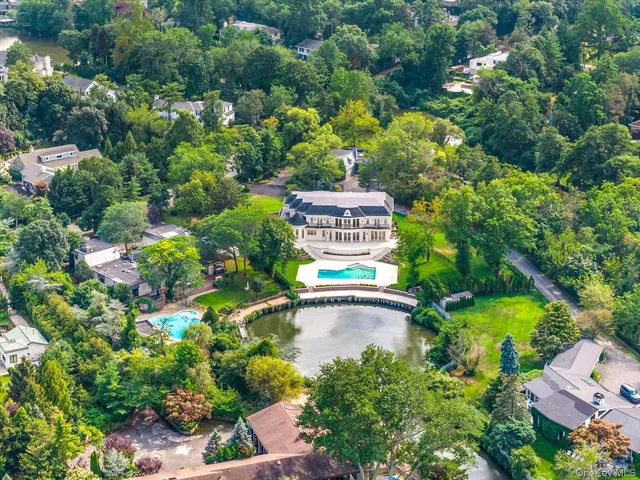 an aerial view of residential house with outdoor space and swimming pool
