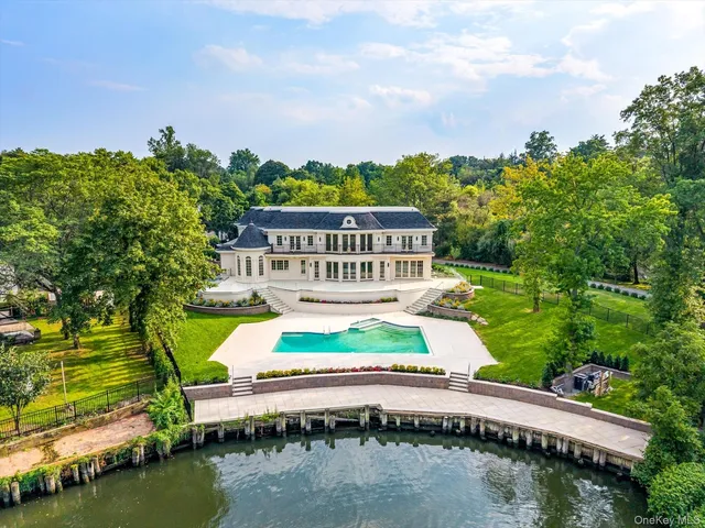 a view of a house with a yard from a lake view