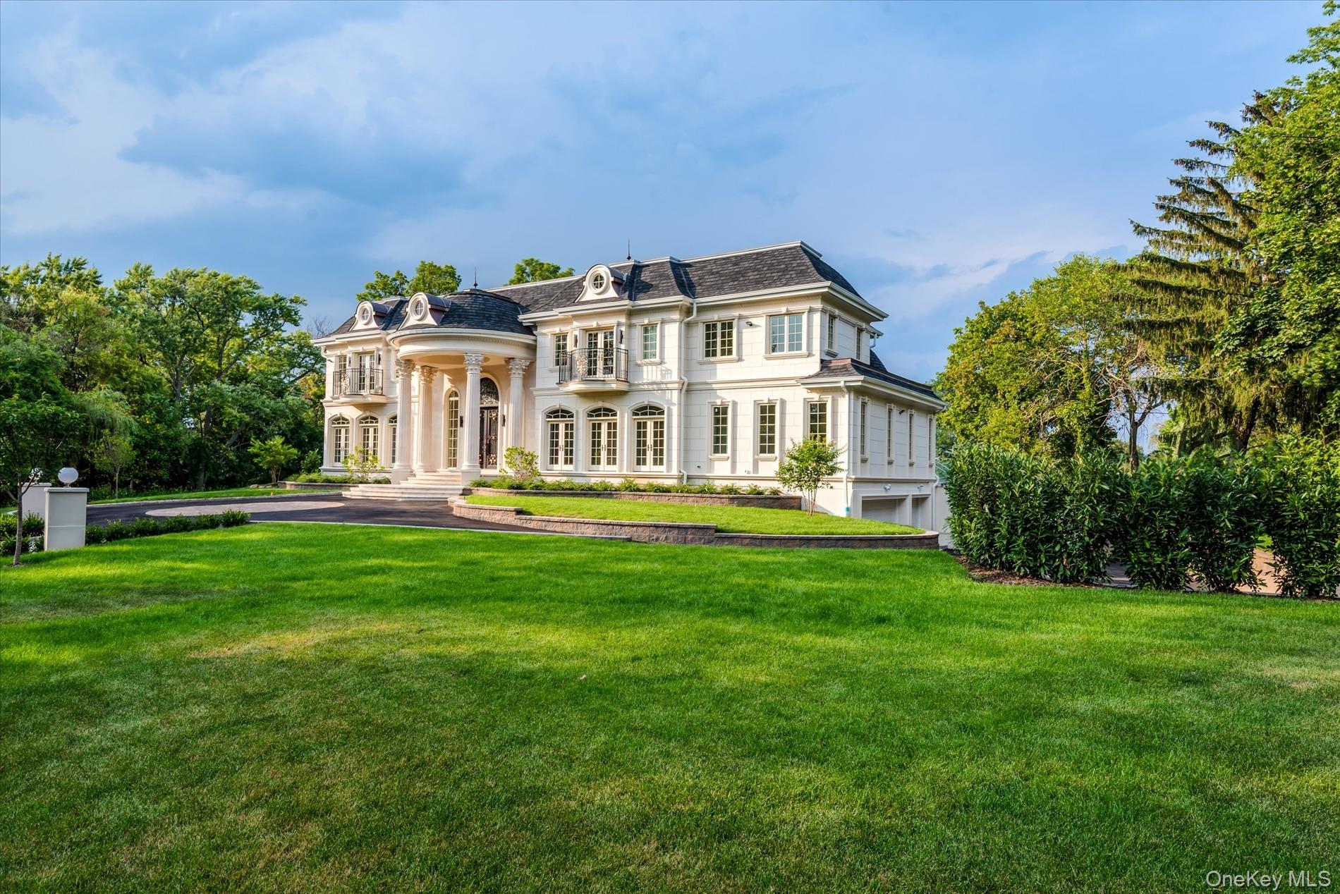 566 East Shore Road Great Neck, NY 11024 - Photo 45 of 50 a front view of a house with a yard