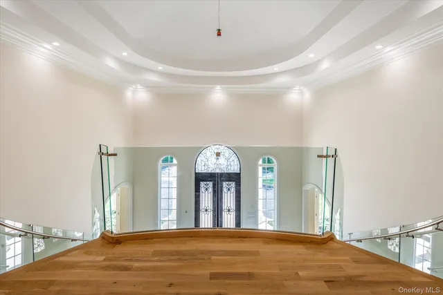 a view of a hallway with entryway window and wooden floor