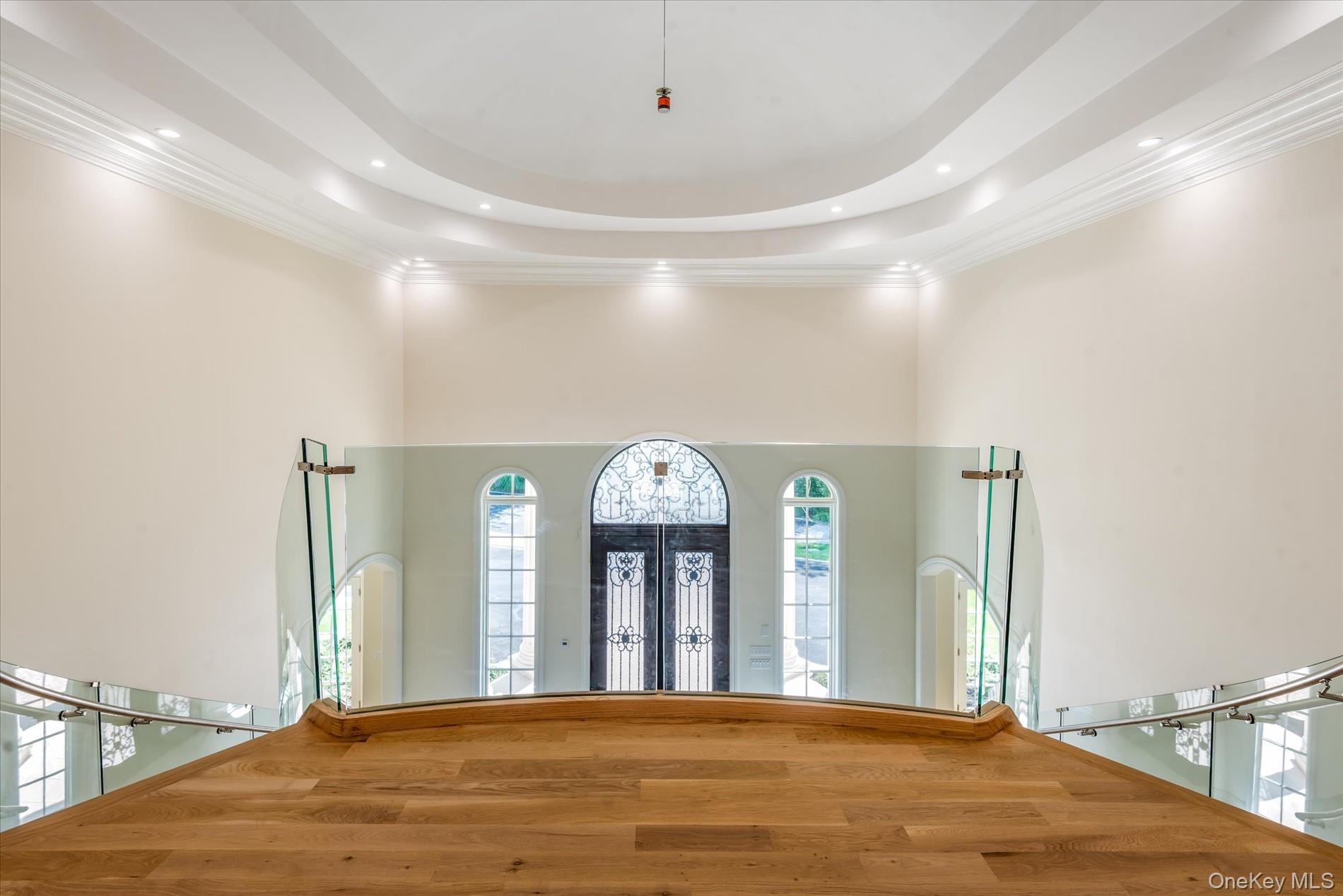 566 East Shore Road Great Neck, NY 11024 - Photo 5 of 50 a view of a hallway with entryway window and wooden floor