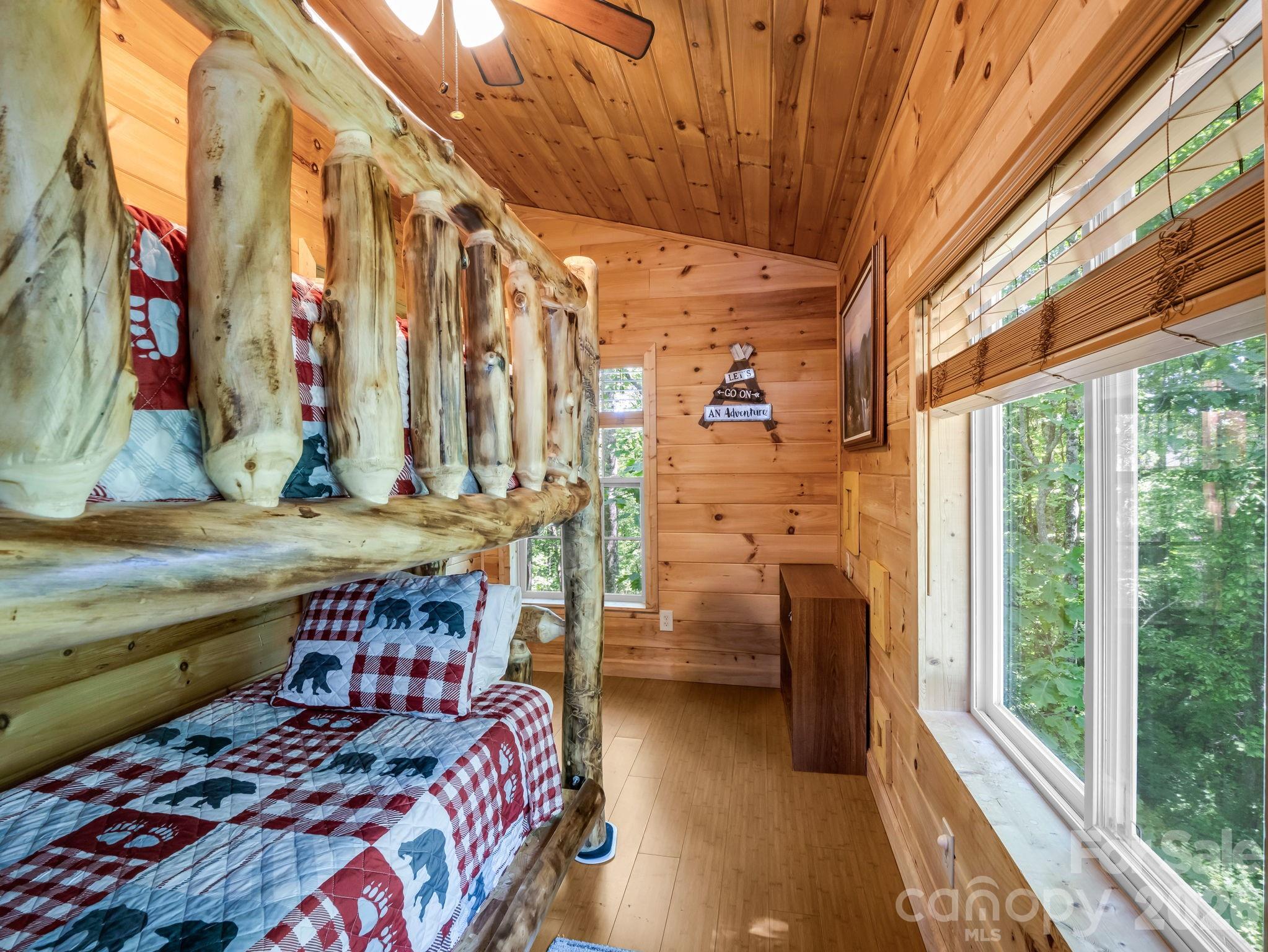 165 Dream Road Hendersonville, NC 28792 - Photo 22 of 46 a bedroom with a bed and large windows