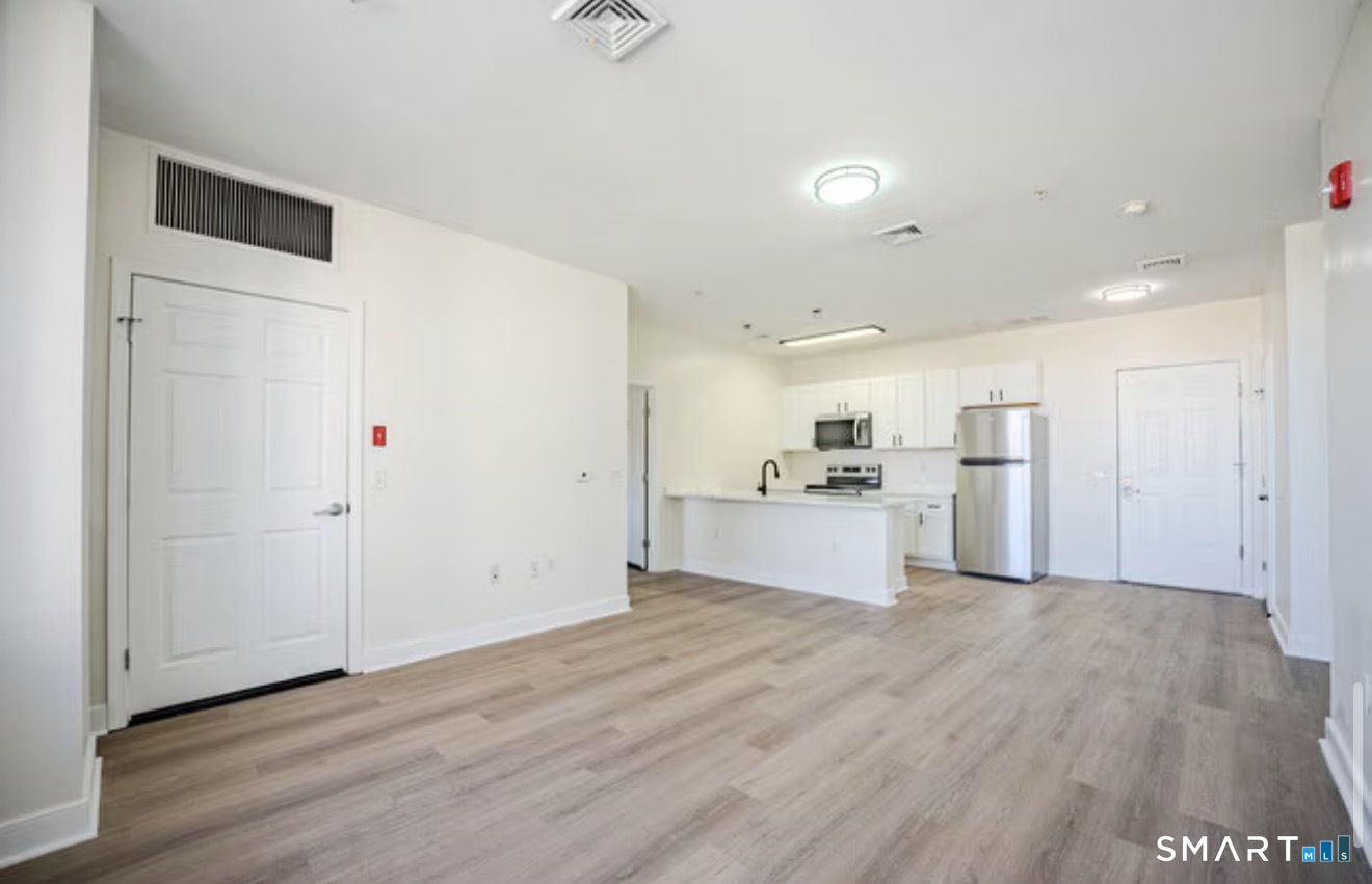 333 State Street, Unit 104 Bridgeport, CT 06604 - Photo 1 of 4 a view of kitchen with wooden floor