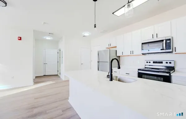 a kitchen with stainless steel appliances a stove sink and cabinets