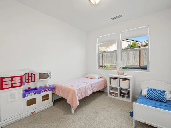 a bedroom with a bed and large window
