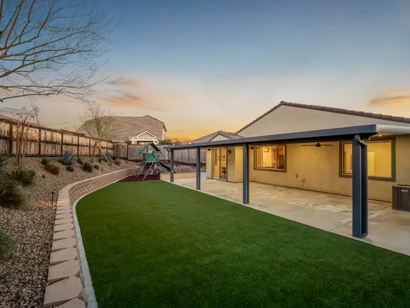a view of a backyard with a slide trees