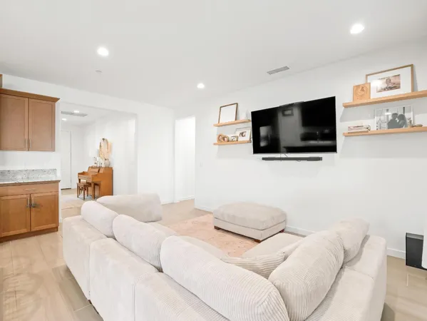 a living room with furniture and kitchen view