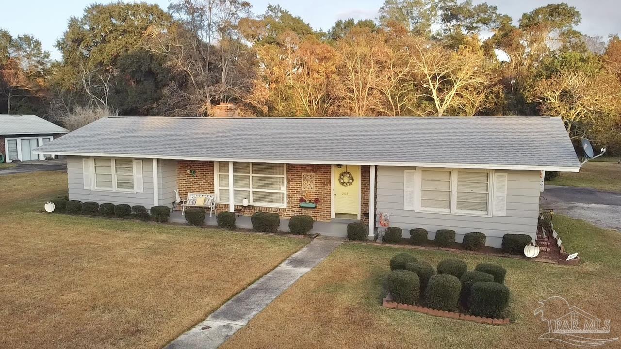 205 Highland Avenue Atmore, AL 36502 - Photo 2 of 43 a front view of a house with a yard and seating space