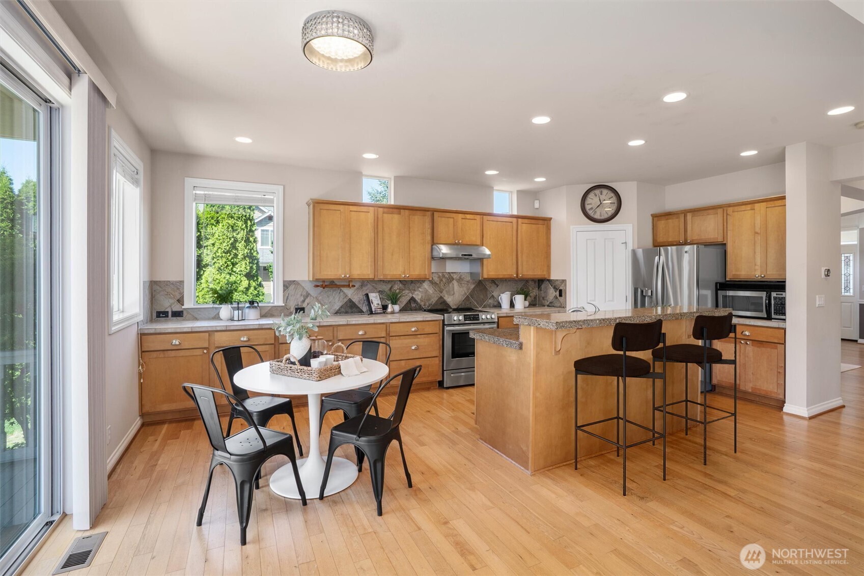 5503 Northeast 2nd Court Renton, WA 98059 - Photo 6 of 39 a kitchen with a dining table chairs and view living room