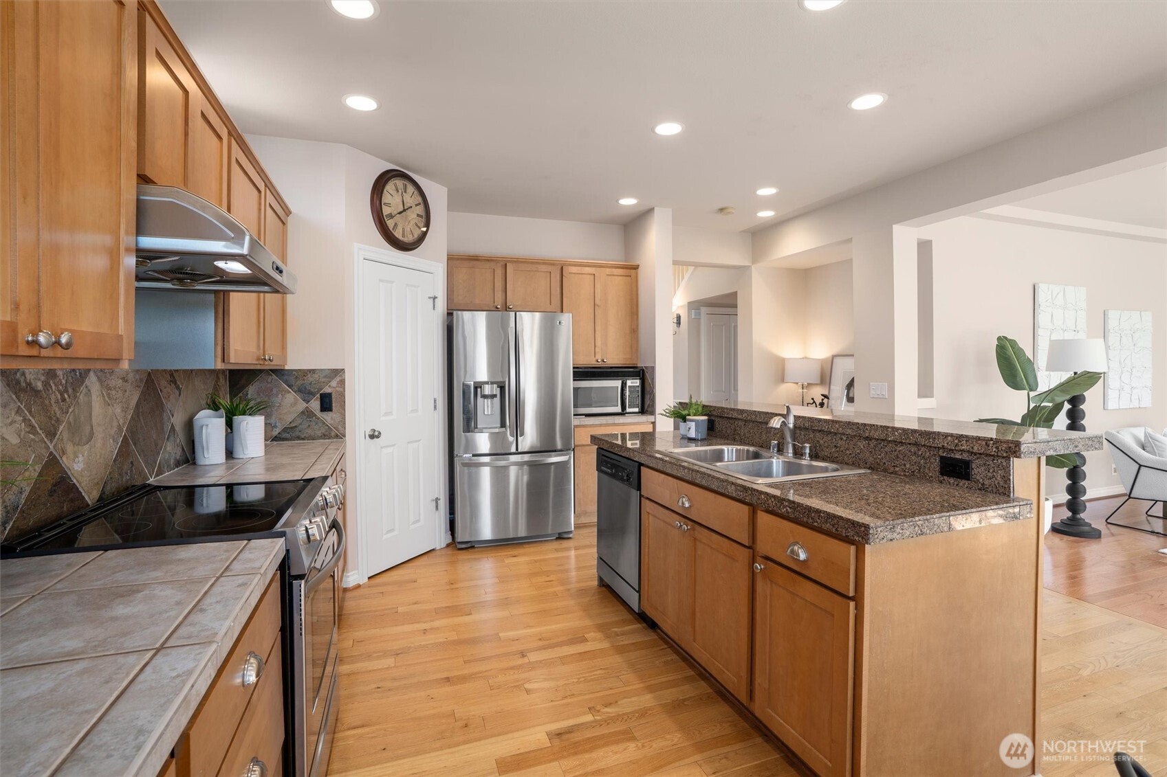 5503 Northeast 2nd Court Renton, WA 98059 - Photo 8 of 39 a kitchen with stainless steel appliances granite countertop a sink stove and refrigerator