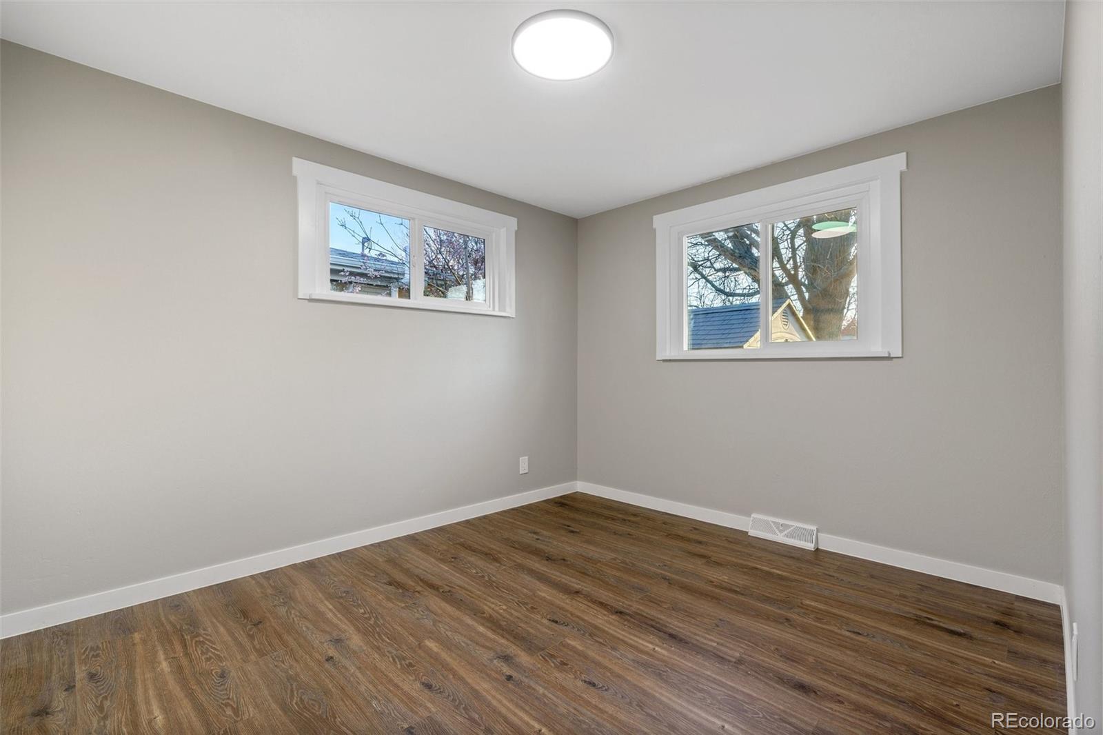 1853 South Decatur Street Denver, CO 80219 - Photo 11 of 22 a view of room with wooden floor and window