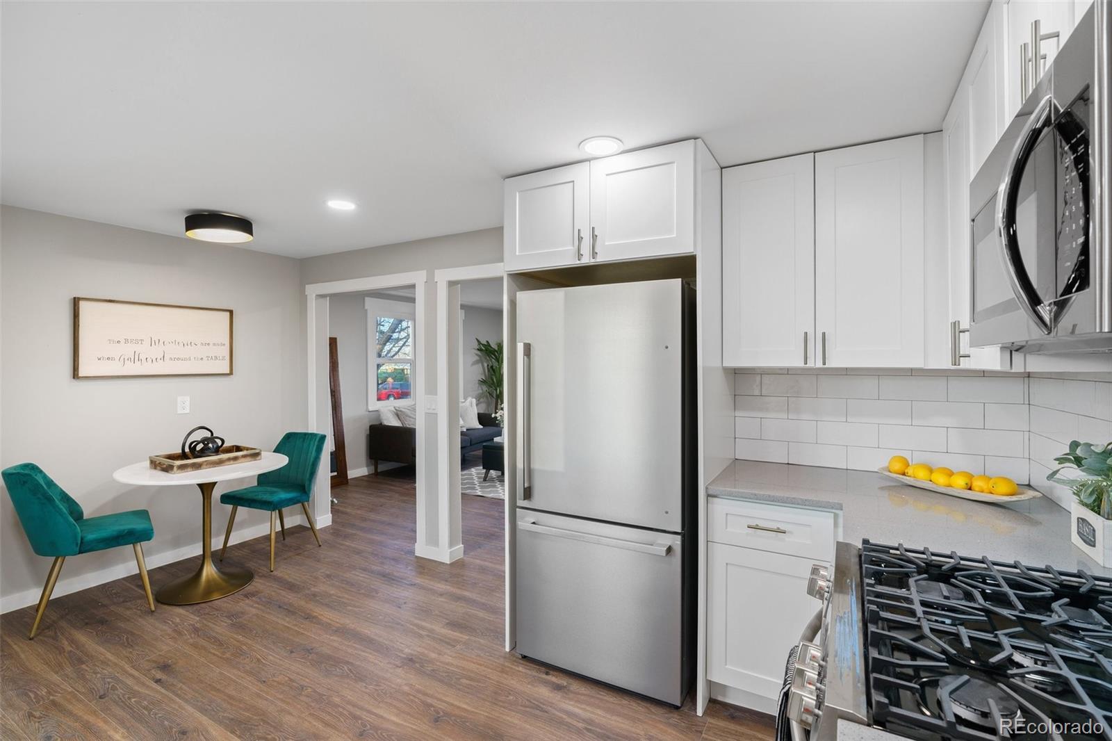 1853 South Decatur Street Denver, CO 80219 - Photo 8 of 22 a kitchen with stainless steel appliances a refrigerator and a stove top oven