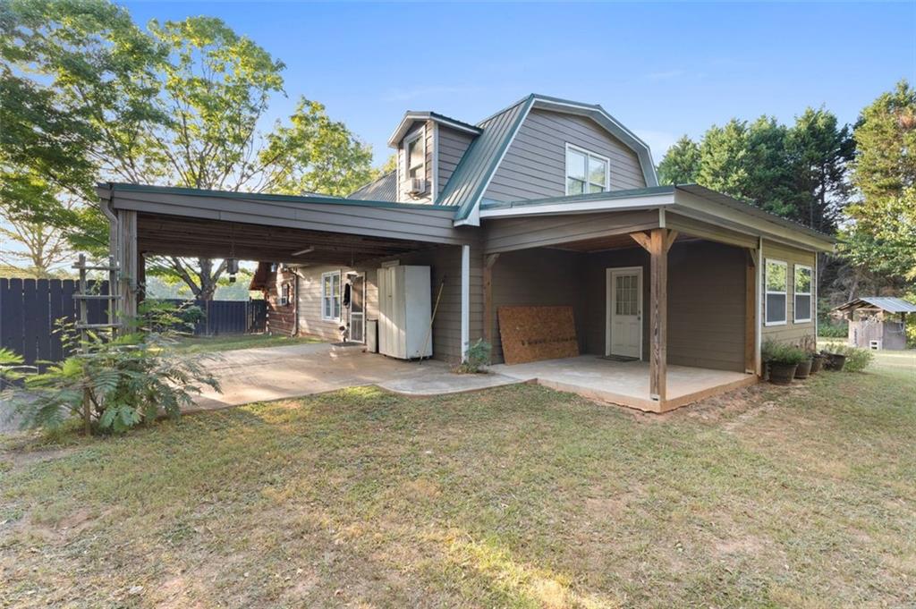 a view of a house with large windows and a tree