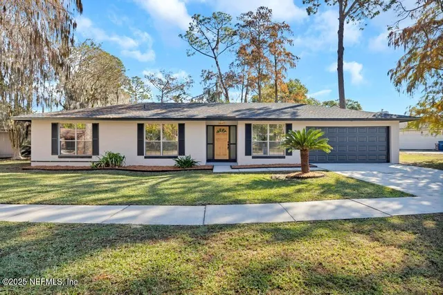 a view of a house with a yard and swimming pool