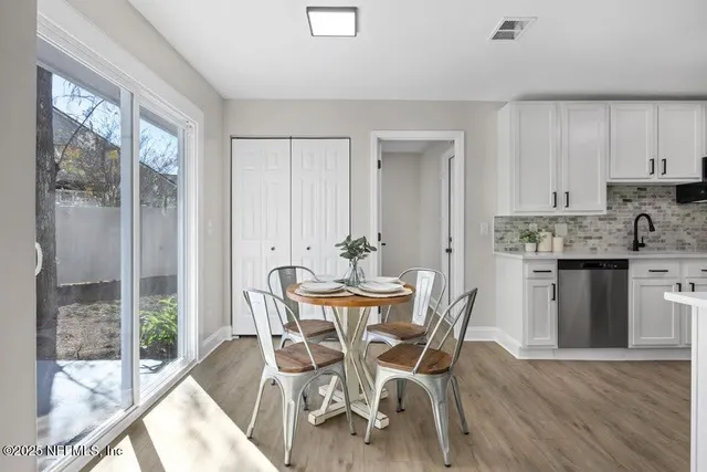 a view of a dining room with furniture and wooden floor