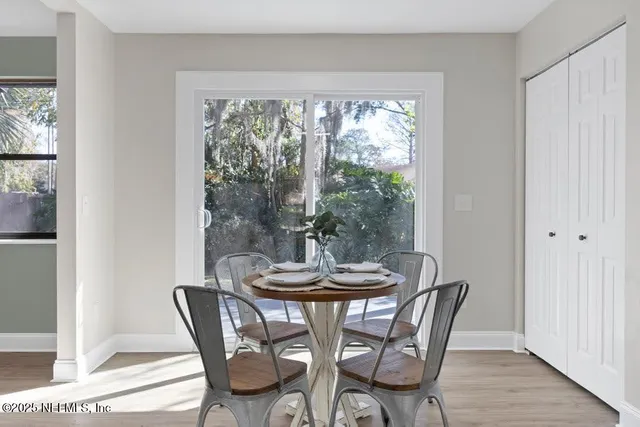 a dining room with furniture and wooden floor