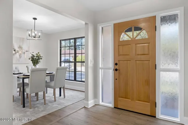 a view of a dining room with furniture window and wooden floor