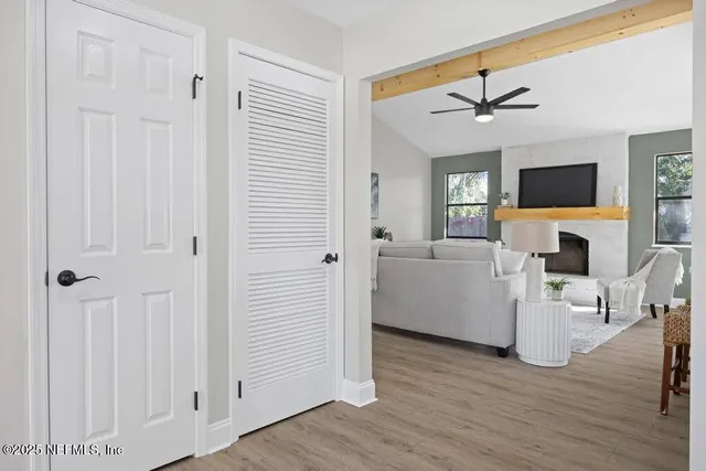 a living room with furniture a fireplace and a flat screen tv